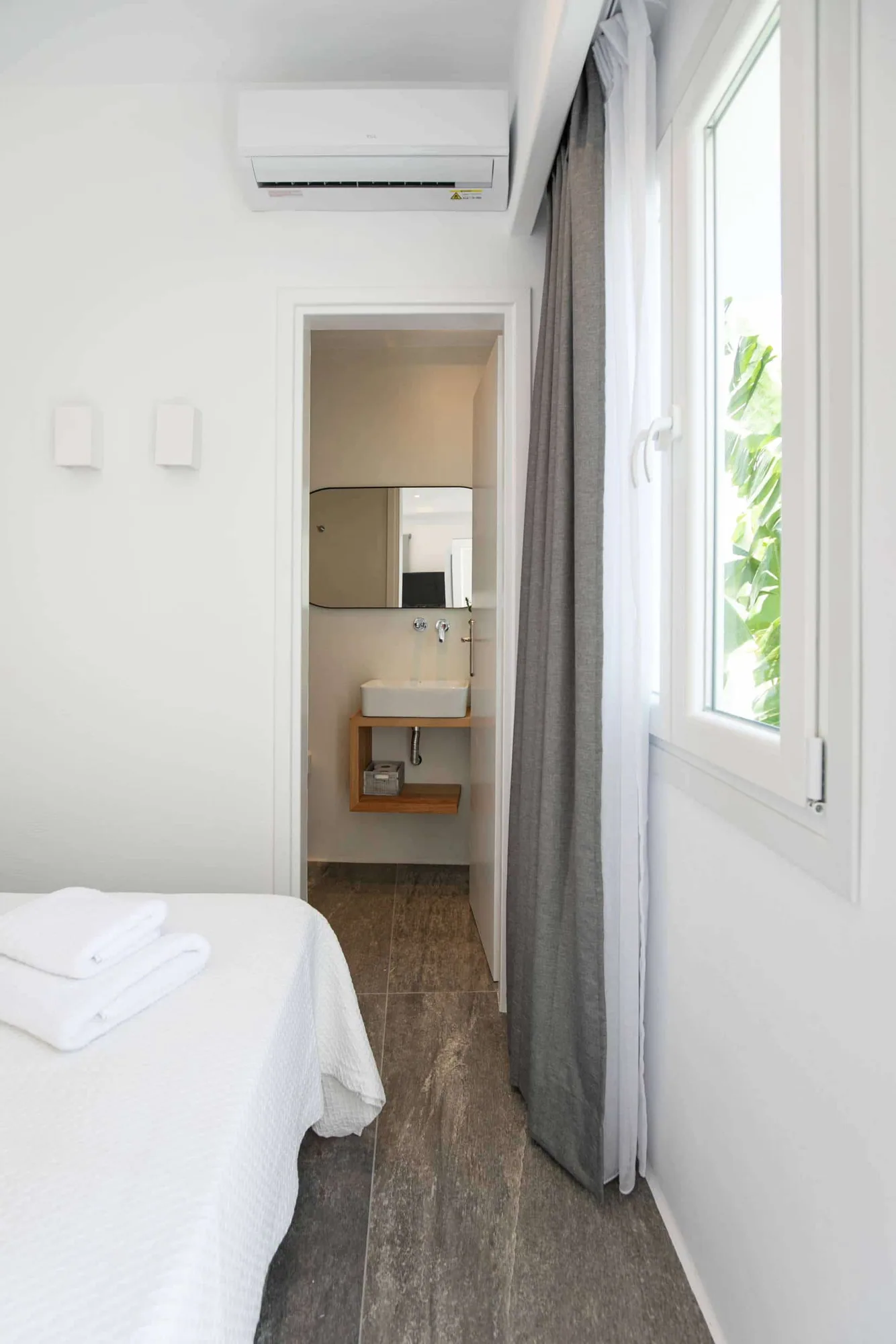 Bedroom corner with window and mirror